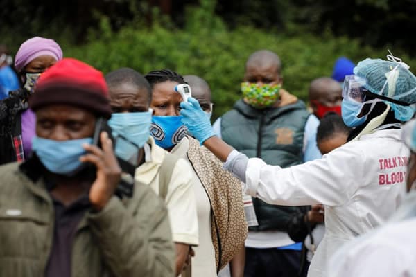 Image of line of people being tested for Covid 19