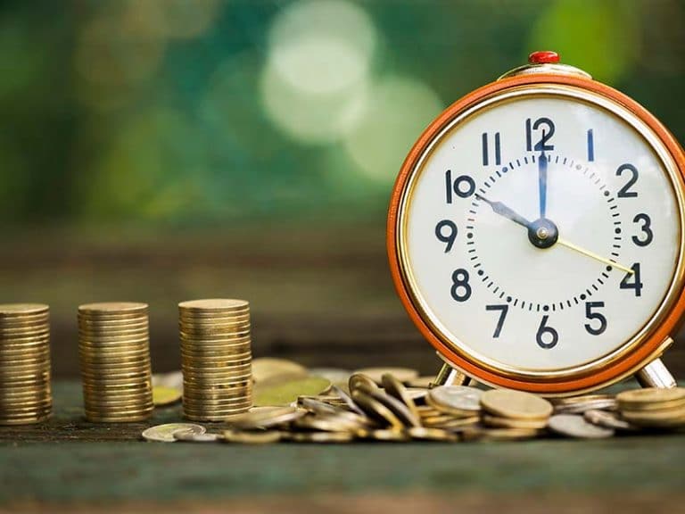 A photo Showing a collection of coins and a clock