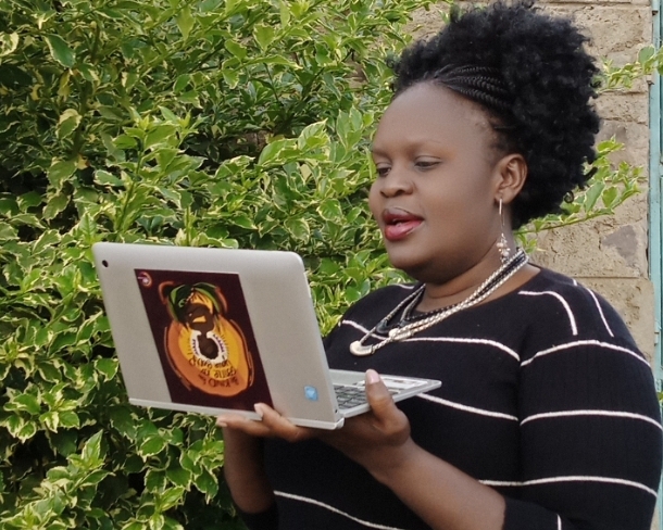 Eunice Owino with laptop in hand