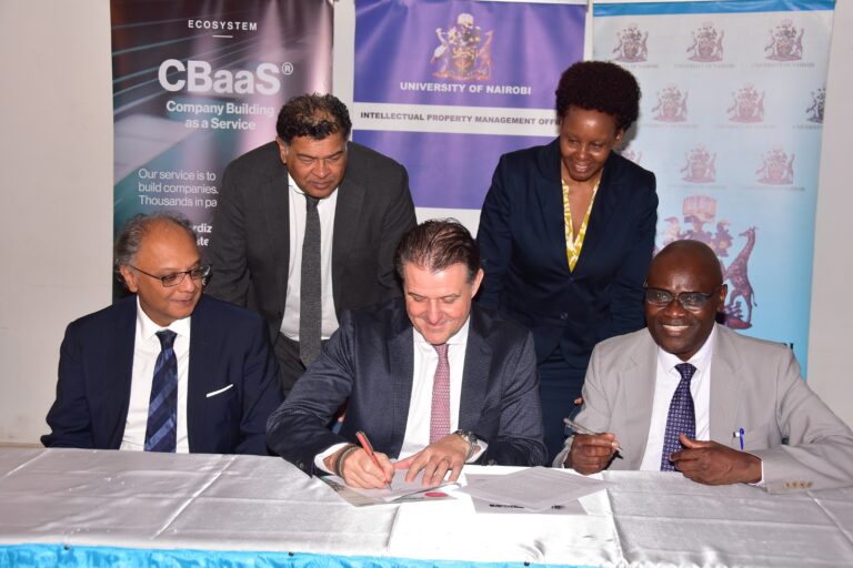 Left-right: TheFactor-Y Partner & Academic Board member Dr. Kevit Desai, TheFactor-Y Head of Strategy Stefan Karlen, and University of Nairobi DVC for Research & Innovation Prof. Francis Mulaa during the signing of the Memorandum of Understanding. Looking on are TheFactor-Y’s Business Development Director Andre Varma (standing, left) and University of Nairobi's Prof. Mary Kinoti (standing, right).