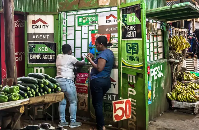 MPesa Agent Serving a Customer