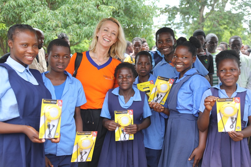 Nicole Watson posses with some beneficiaries of the lights.